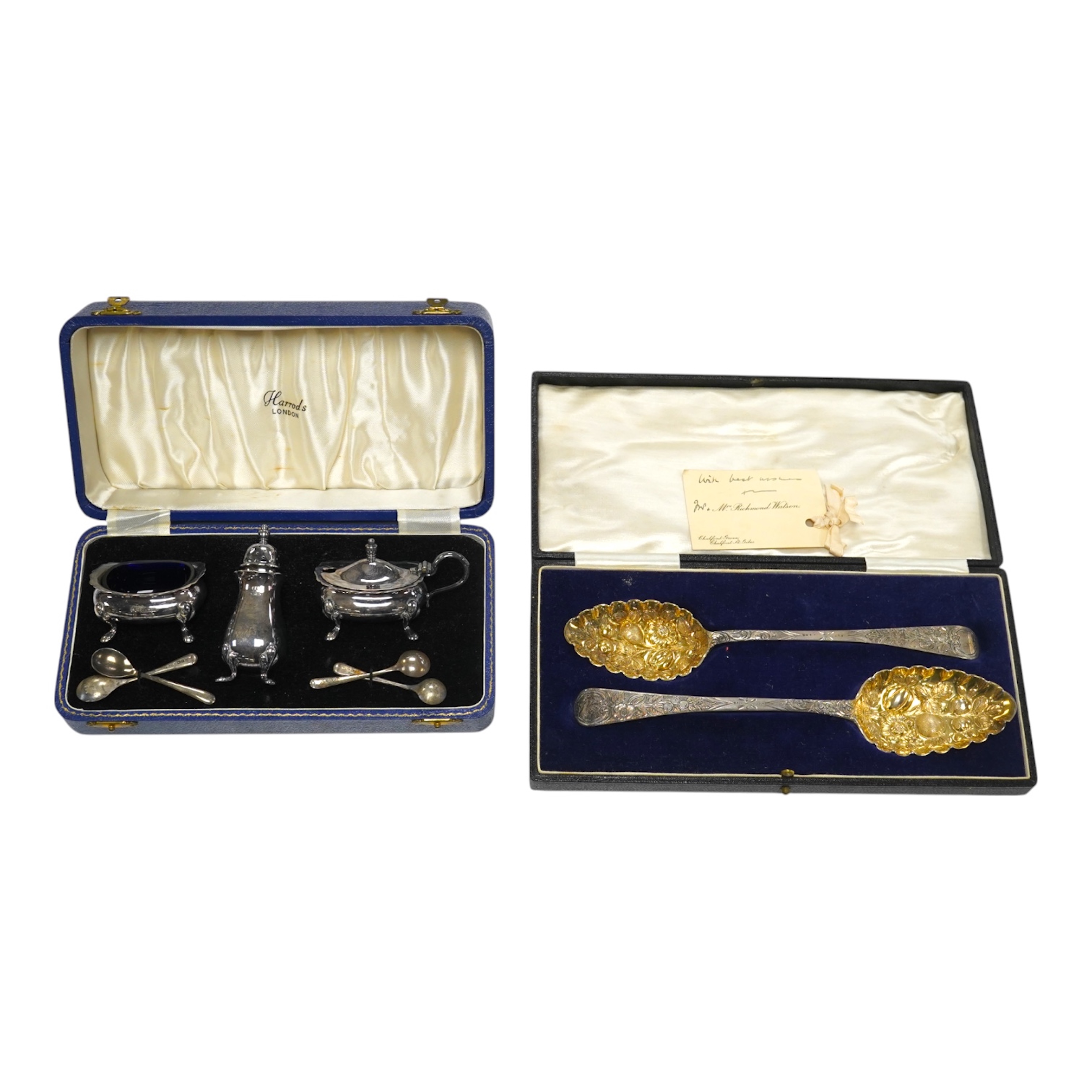 A cased 1960's three piece silver condiment set by William Suckling Ltd and and a cased pair of George III silver berry spoons, George Smith IV, London, 1812. Condition - fair